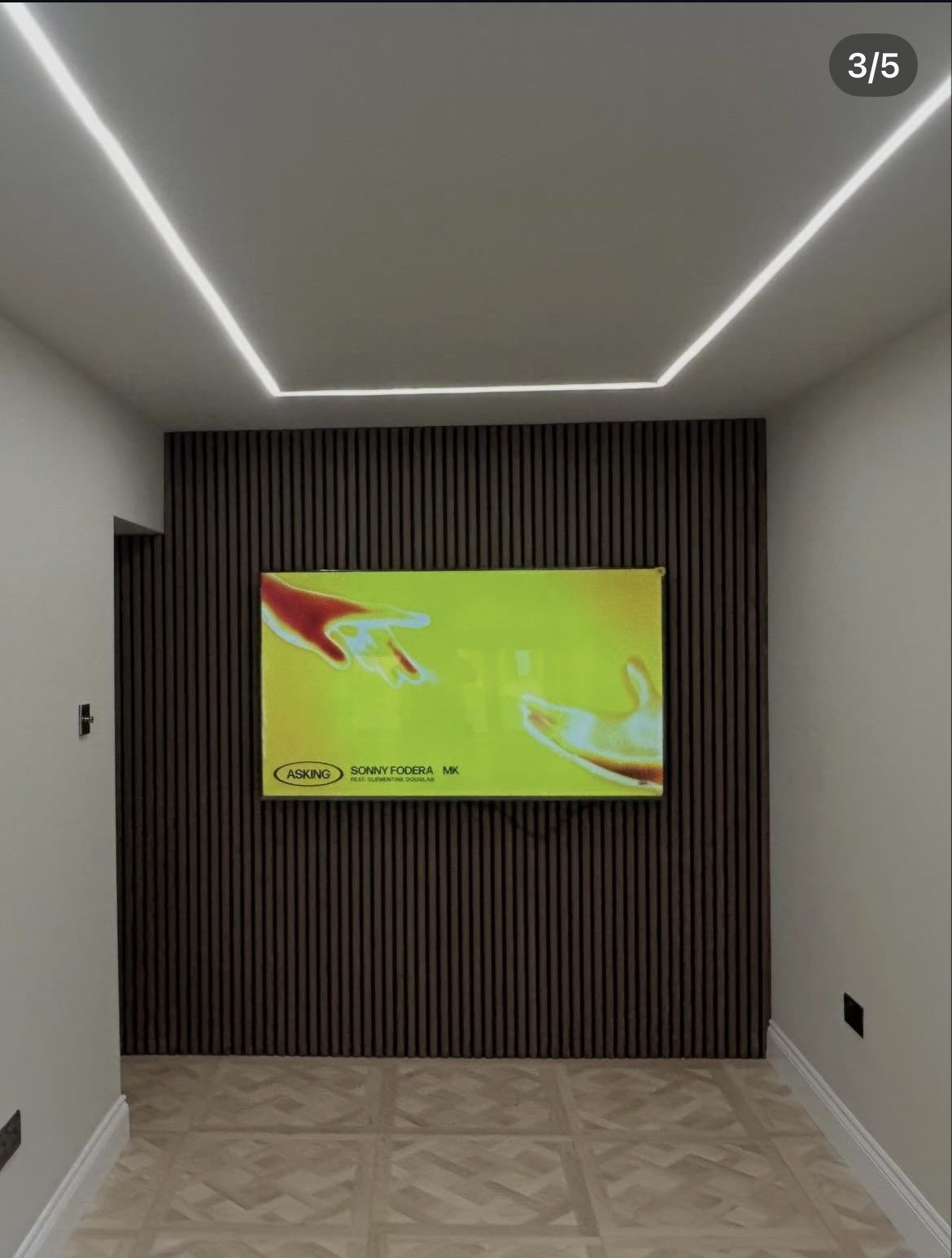 Renovated bedroom with recessed LED ceiling lighting and patterned tiled flooring