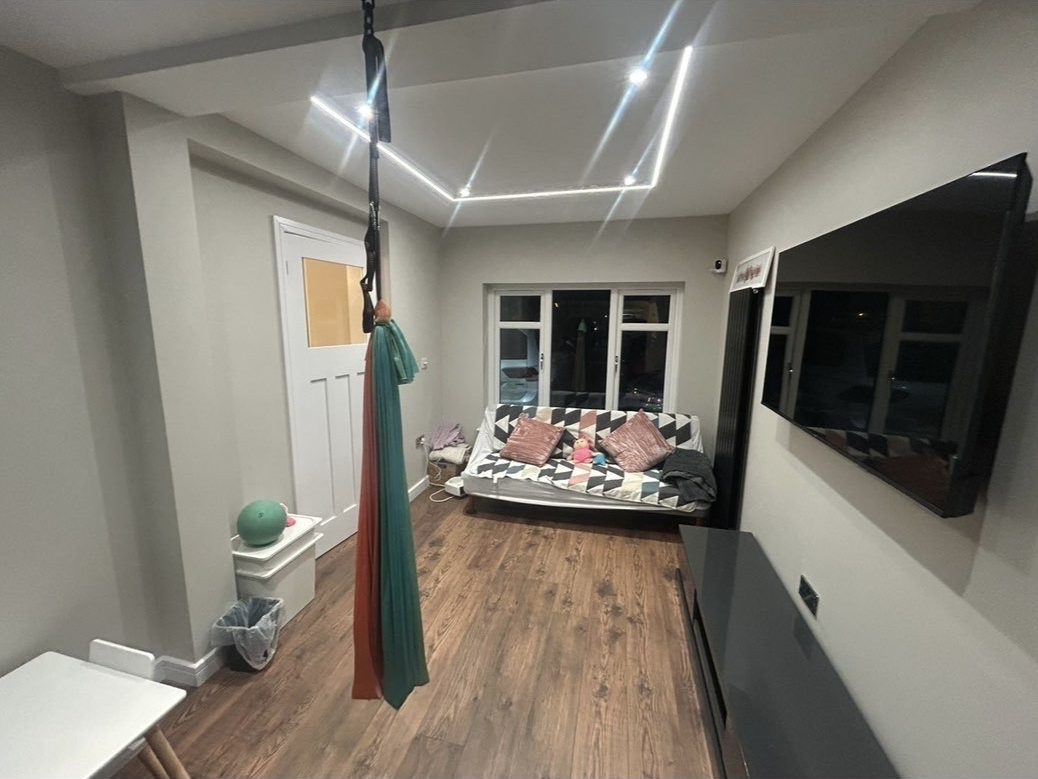 Multi-use garage conversion fitted out as a lounge and activity space